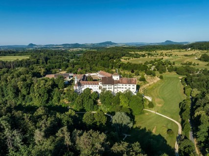 Aerial view of Langenstein Castle near Eigeltingen with surrounding golf course, on the horizon the