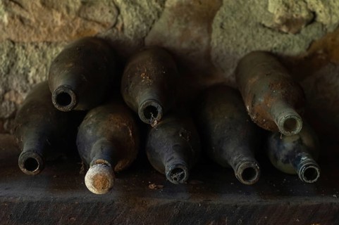 Old empty wine bottles standing abandoned on a shelf. Bas-Rhin, Collectivite europeenne d'Alsace,