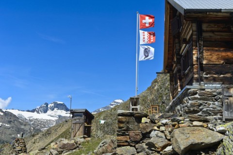 Flagpole with the flags of Switzerland, the canton of Valais and the Academic Alpine Club of Bern