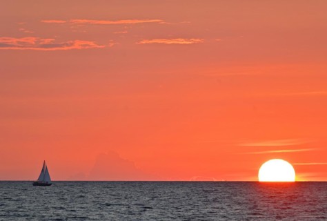 Sailboat sailing in the evening towards the setting sun, Baltic Sea, Poel Island,
