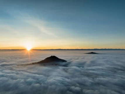 Aerial view of the wintry and fog-covered Hegaulandschaft at sunrise, the volcanic cones Hohenhewen