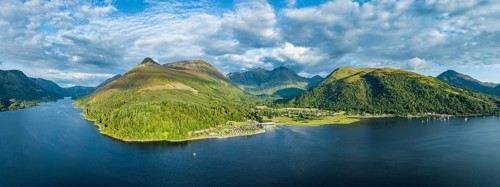Aerial panorama of the freshwater loch Loch Leven with the village of Glen Coe, above it the 742