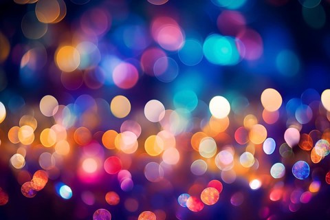 An abstract and colorful defocused blurred bokeh background with bright lights and festive