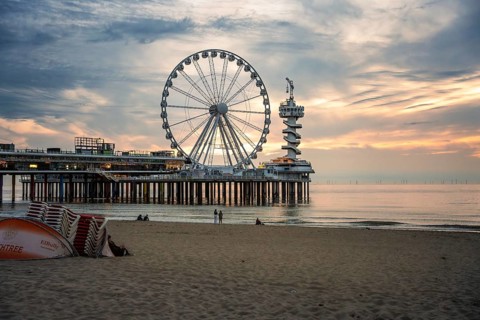 Ferris wheel at sunset on the pier at the beach, The Hague, Netherlands