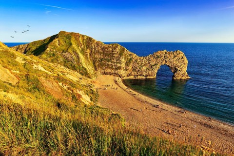 Coastline with bathing beach at Durdle Door, limestone rock bridge, UNESCO World Heritage Site,