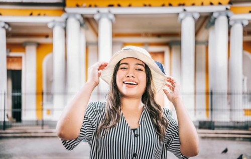 Portrait of a tourist girl with hat in a tourist square. Granada, Nicaragua. Portrait of smiling