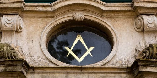 Close-up with compass and angle, two of the best-known symbols of Freemasonry on the lodge house,