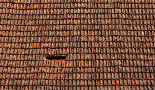 Old weathered tiled roof with missing tiles, residential building, Austria, Europe