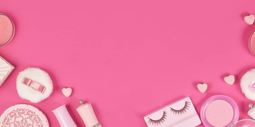 Banner with cute pink makeup beauty products like brushes, powder or lipstick on sides of pink