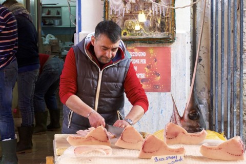 Fish seller, carving swordfish (Xiphias gladius), markets, open air, Palermo, capital, Sicily,