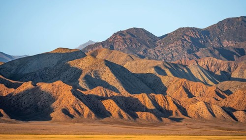 Dry mountains in the evening light, Toktogul reservoir, Jalalabad region, Kyrgyzstan, Asia