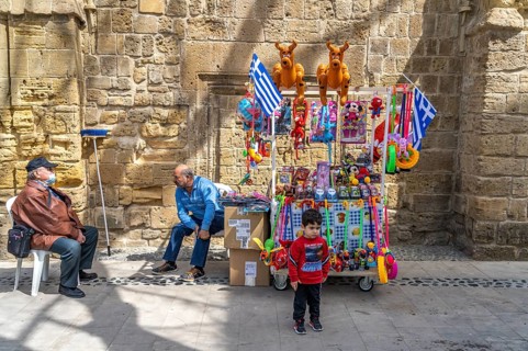 Little boy in front of a stall with toys in Nicosia, Cyprus, Europe
