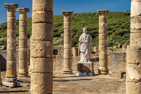 Trajan statue and basilica of the Roman ruins of Baelo Claudia in Bolonia, Tarifa, Costa de la Luz,