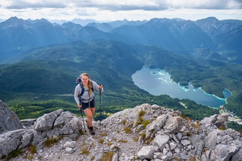 Hiker in the mountains, view of Eibsee lake and Werdenfelser Land, Wetterstein Mountains,