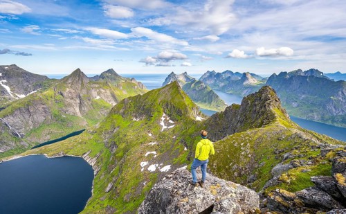 Mountaineers at the summit of Munken, mountain landscape with steep rocky mountain peaks, lake