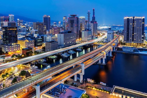 Kobe skyline from above with harbour and elevated roads at night in Kobe, Japan, Asia