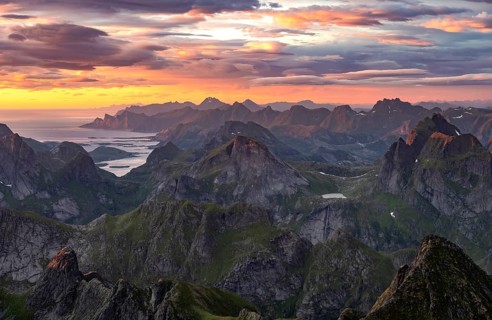 View over mountain top and sea, dramatic sunset, from the top of Hermannsdalstinden, Moskenesöy,