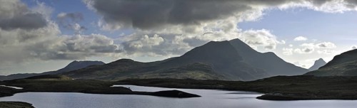 Highland scenery with loch and rain clouds at Assynt, Sutherland, Scotland, UK