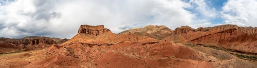 Eroded mountain landscape with sandstone cliffs, red and orange rock formations, Konorchek Canyon,