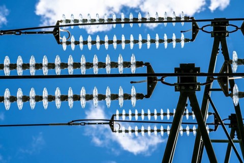 Insulators made of glass on a high-voltage line, they hang on the pylons as a suspension device