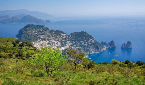 View from Monte Solaro 589m to the south coast with the Faraglioni rocks, the island's landmarks,