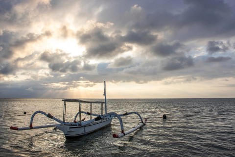 Jukung in the sea, typical landscape shot with a view of the horizon over the water, taken from a