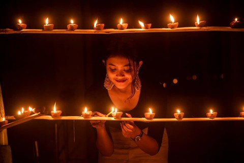 Students of Cotton University lighting diya (Clay lamp) on the occasion of Diwali Festival, on