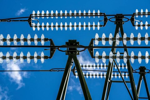 Insulators made of glass on a high-voltage line, they hang on the pylons as a suspension device