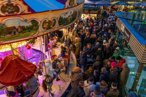 Historic horse-drawn carousel at the Christmas market on the Heumarkt in the old town of Cologne,