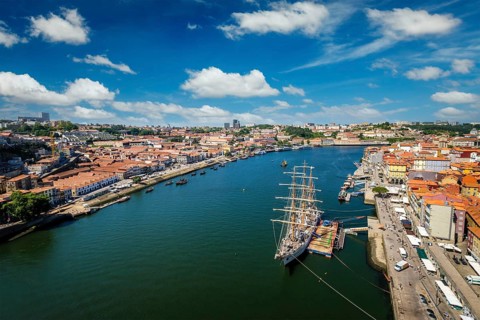 Aerial view of Porto city and Vila Nova de Gaia and Douro river with moored sailling ship from Dom