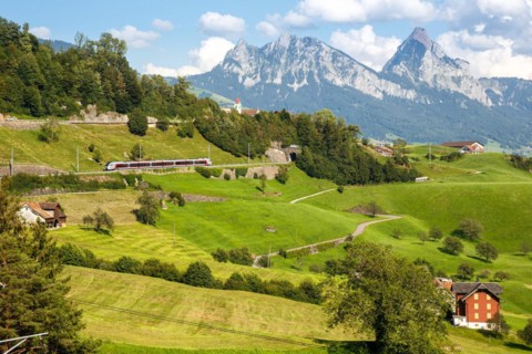 Railway passenger train of the type Stadler Flirt of the Südostbahn on the mountain GroÃŸer Mythen