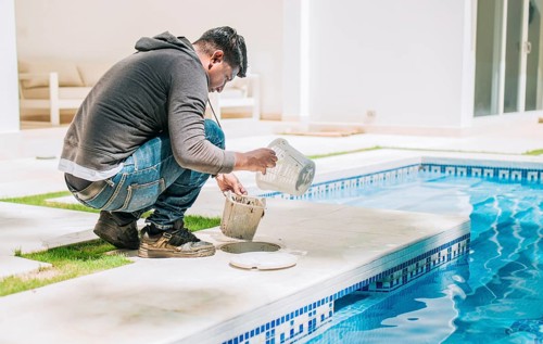 Person cleaning garbage filter basket for swimming pool. Man cleaning swimming pool filter basket
