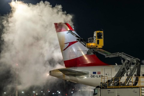 Winter at Frankfurt Main Airport, FRA, Austrian aircraft being de-iced by de-icing vehicles, Hesse,