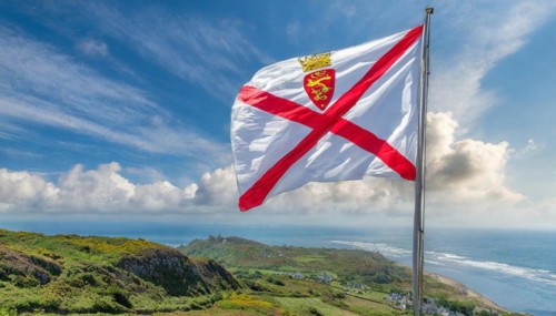 The flag of the Isle of Jersey, Great Britain flutters in the wind