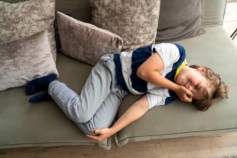 Growing pains in children, boy, 10 years old, has pain in his leg, symbolic picture