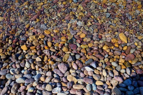 Colourful pebbles on the shore with diverse patterns and textures, Lambi beach, pebble beach,