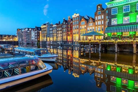 Canal houses on the Damrak, in the centre of the old town of Amsterdam, harbour, starting point of