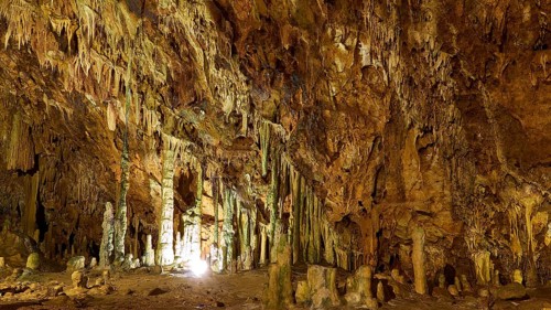 Wide cave hall with illuminated stalactites and stalagmites, stalactite cave, Diros Cave, Glyafada