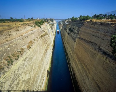 A cargo ship travels through a canal-like waterway with steep, dry walls, Corinth Canal, Corinth,