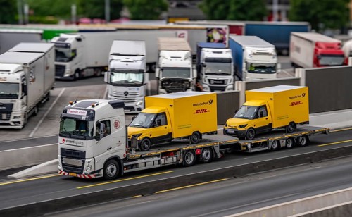 Car transporter with 2 new delivery vehicles for Deutsche Post, DHL, electric vehicles, on the A2