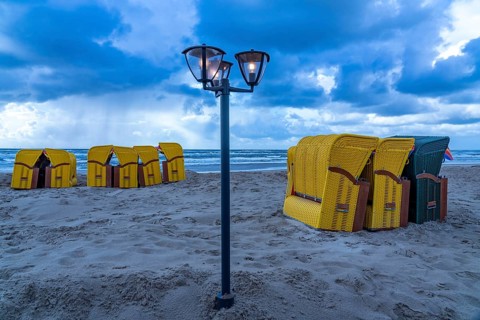 End of the season on the beach, dark storm clouds, choppy sea, autumn on the North Sea in North