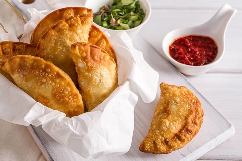 Fried chebureks, close-up, on a white background, no people
