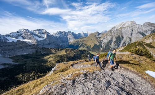 Two mountaineers on a hiking trail, mountain panorama with rocky steep peaks, view of summits