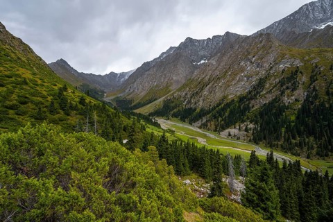 Green mountain valley with river and steep mountain peaks, Chong Kyzyl Suu Valley, Terskey Ala Too,