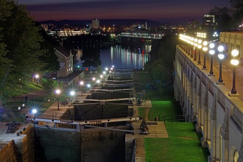 Night scene of a city on a river with illuminated locks and buildings, Rideau Canal, Ottawa,