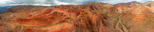 Eroded mountain landscape, canyon with red and orange rock formations, aerial view, Konorchek