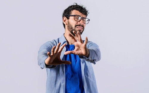 Young man with rejection expression isolated. Man with scared expression on his face making