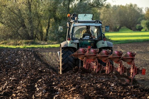 Farmer ploughing a field, tractor with plough, near Neuss, North Rhine-Westphalia, Germany, Europe