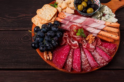Appetizer, assortment, set, sausage, and cheese, on a wooden board, top view, no people