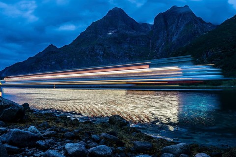 Hurtigruten cruise ship passes the Raftsund at night, long time exposure, the strait between